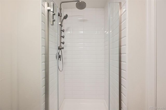 bathroom with tiled shower