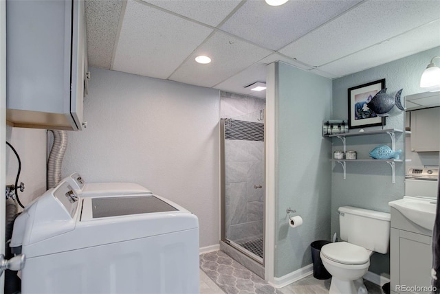 full bath with vanity, a stall shower, washer and dryer, and toilet