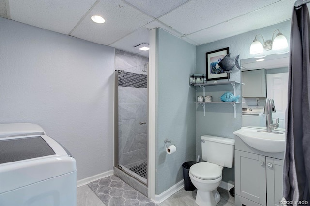 bathroom featuring baseboards, a stall shower, toilet, and independent washer and dryer