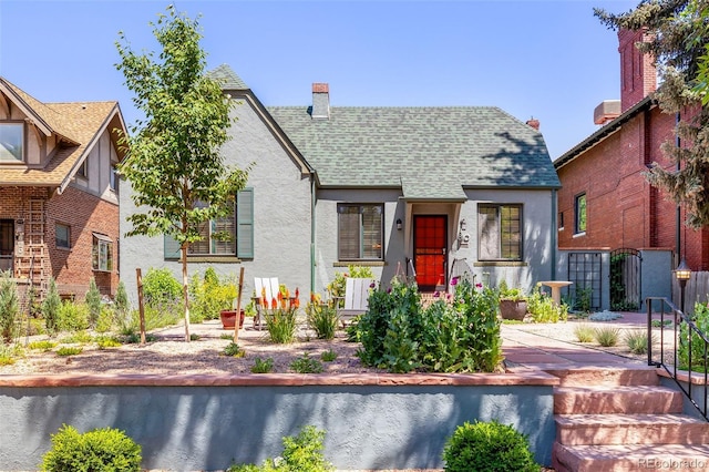 810 Milwaukee St, Denver, CO 80206 - english style home with stucco siding, a shingled roof, and a chimney