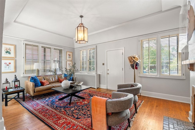 810 Milwaukee St, Denver, CO 80206 - living area featuring radiator, light wood finished floors, plenty of natural light, and a chandelier