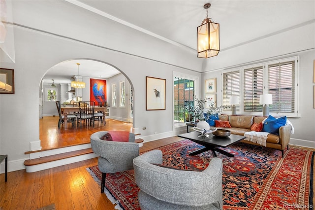 810 Milwaukee St, Denver, CO 80206 - living room with arched walkways, wood finished floors, a chandelier, and plenty of natural light