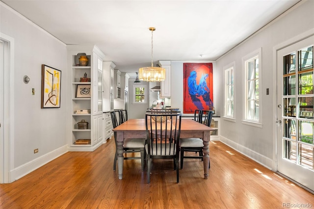 810 Milwaukee St, Denver, CO 80206 - dining space with a chandelier, light wood-style floors, crown molding, and built in shelves