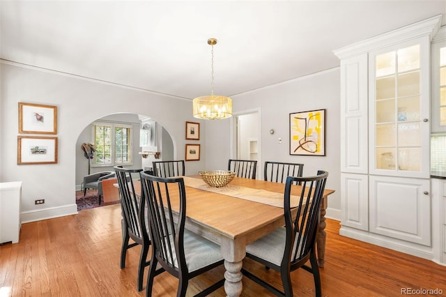 810 Milwaukee St, Denver, CO 80206 - dining room with arched walkways, a chandelier, and light wood-style floors