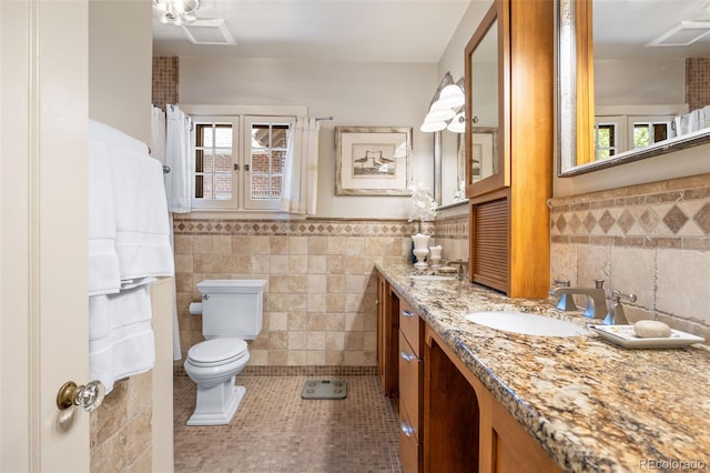 810 Milwaukee St, Denver, CO 80206 - full bathroom featuring tile walls, tile patterned floors, plenty of natural light, vanity, and wainscoting