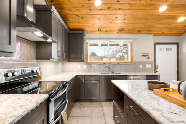 kitchen with dark brown cabinets, wall chimney range hood, double oven range, wood ceiling, and a sink