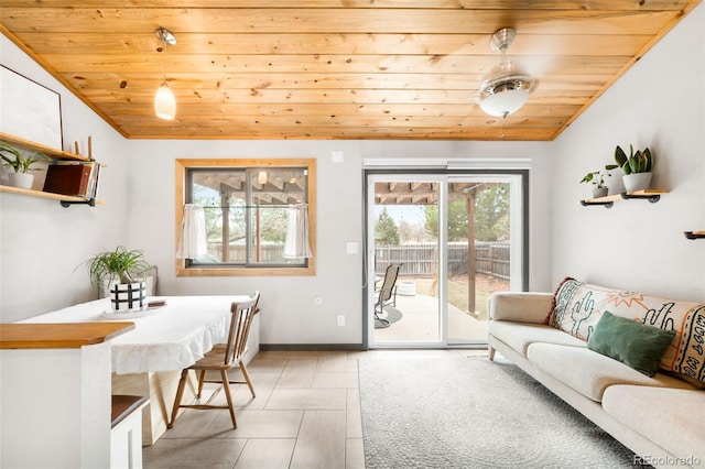 dining room featuring baseboards, wooden ceiling, and vaulted ceiling