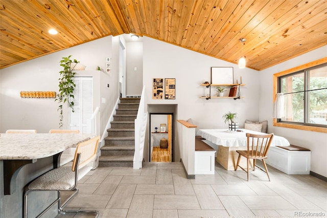 dining room featuring stairway, light tile patterned floors, lofted ceiling, wood ceiling, and breakfast area