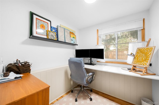 office with wood finished floors and wainscoting