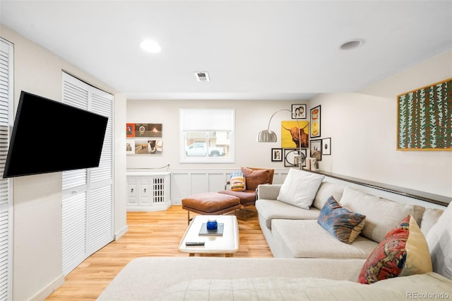 living area featuring recessed lighting, wood finished floors, and visible vents