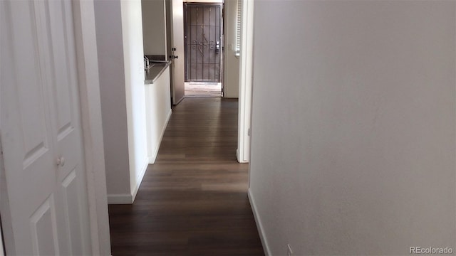 hall with dark hardwood / wood-style flooring