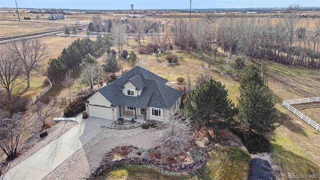 birds eye view of property with a rural view