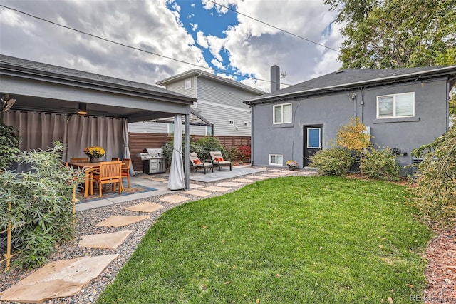 rear view of house with a patio area and a lawn