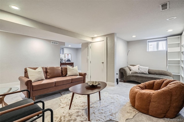 carpeted living room with a textured ceiling