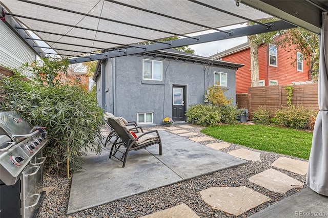 view of patio with a grill and a pergola