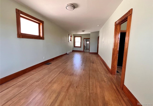 corridor with hardwood / wood-style flooring