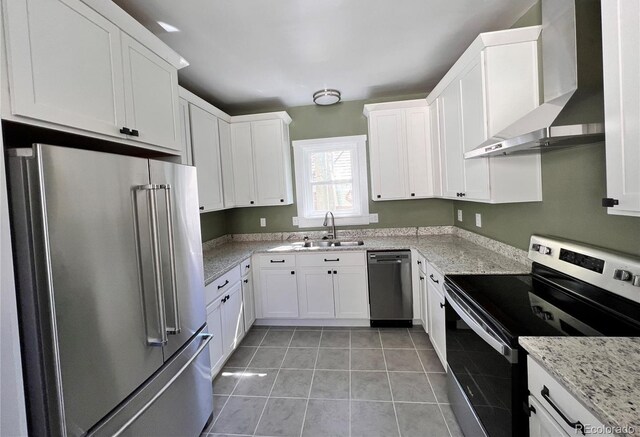 417 E Eaton Ave, Cripple Creek, CO 80813 - kitchen with appliances with stainless steel finishes, wall chimney exhaust hood, white cabinetry, light tile patterned floors, and light stone counters