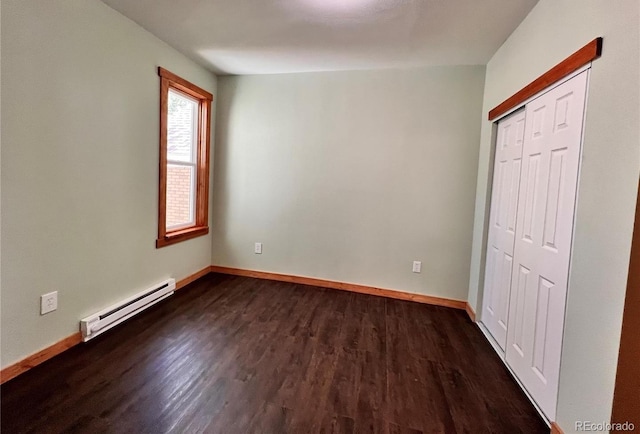 417 E Eaton Ave, Cripple Creek, CO 80813 - unfurnished bedroom with baseboard heating, dark wood-style floors, and a closet