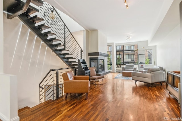 2325 Walnut St Unit 4, Denver, CO 80205 - living area with wood finished floors, stairway, and a multi sided fireplace
