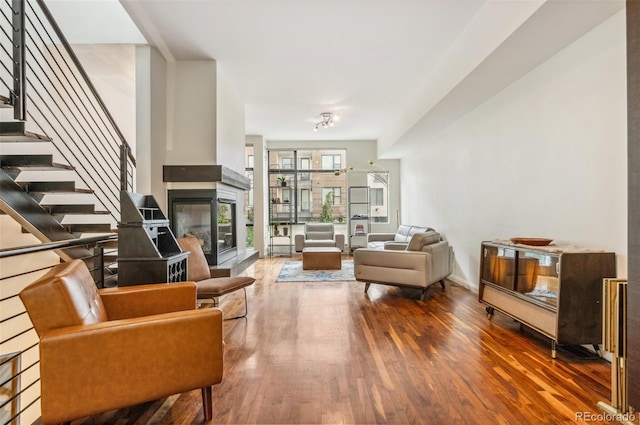 2325 Walnut St Unit 4, Denver, CO 80205 - living area featuring wood finished floors, stairs, and a multi sided fireplace
