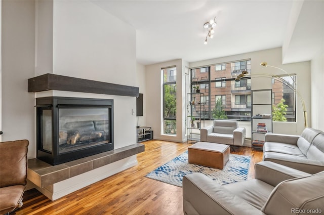 2325 Walnut St Unit 4, Denver, CO 80205 - living area featuring a glass covered fireplace and wood finished floors