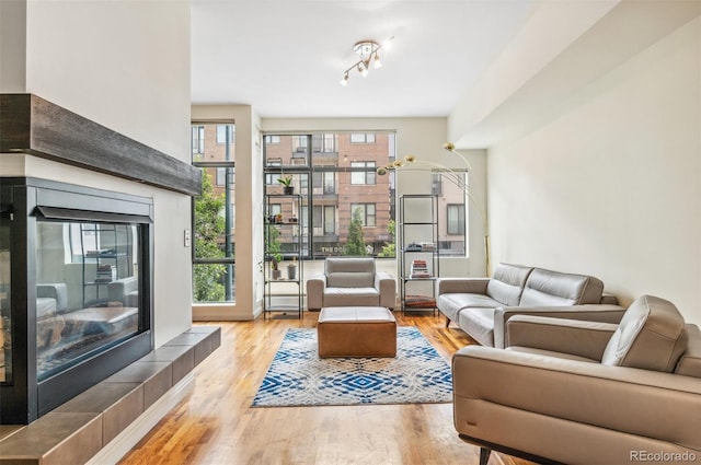 2325 Walnut St Unit 4, Denver, CO 80205 - living area with wood finished floors and a tiled fireplace