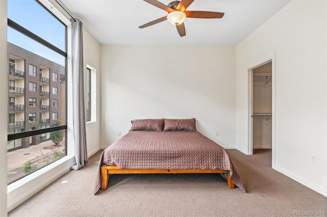 2325 Walnut St Unit 4, Denver, CO 80205 - bedroom featuring carpet floors, baseboards, a ceiling fan, and a walk in closet