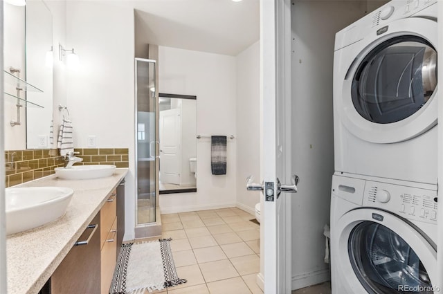 2325 Walnut St Unit 4, Denver, CO 80205 - laundry area with stacked washer / dryer, light tile patterned floors, and baseboards