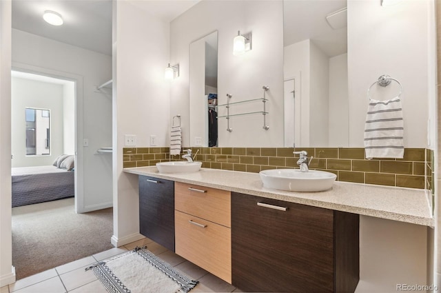 2325 Walnut St Unit 4, Denver, CO 80205 - ensuite bathroom featuring double vanity, tile patterned flooring, decorative backsplash, and baseboards