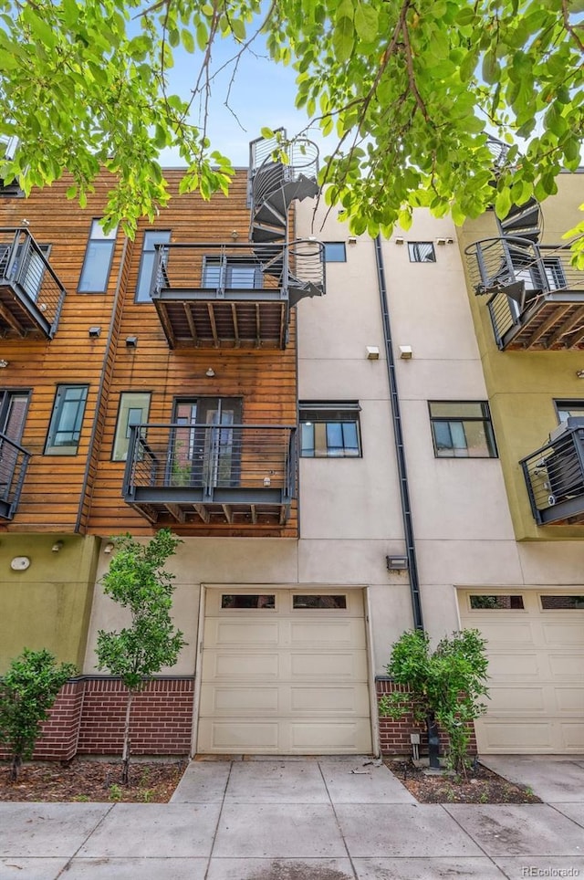 2325 Walnut St Unit 4, Denver, CO 80205 - view of property with a garage and concrete driveway