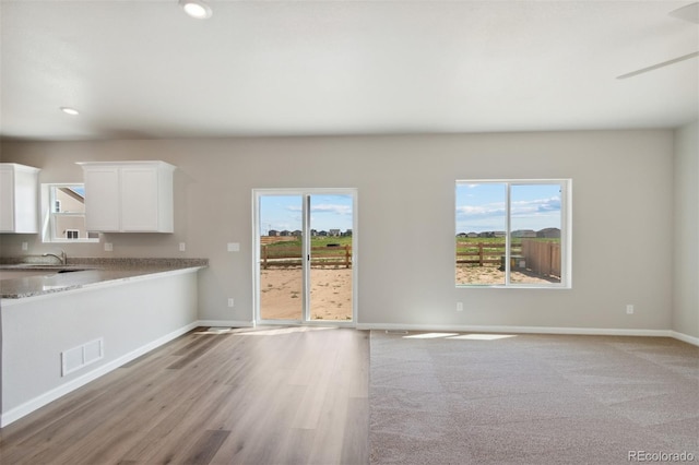 interior space featuring recessed lighting, baseboards, visible vents, and light wood-type flooring