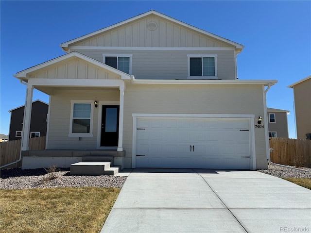 view of front of property featuring concrete driveway, an attached garage, fence, and board and batten siding