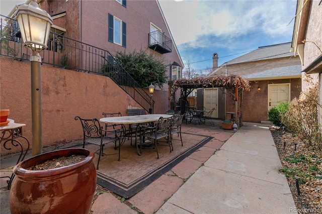 view of patio / terrace featuring stairway and outdoor dining space