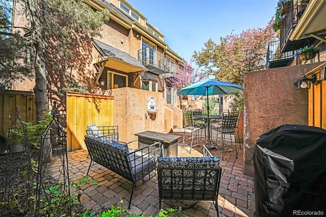 view of patio with fence, an outdoor hangout area, and area for grilling