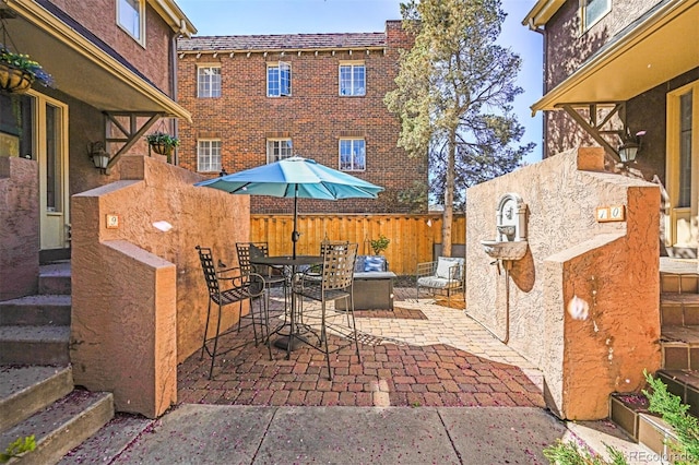 view of patio featuring fence and outdoor dining area