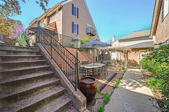 view of patio / terrace with outdoor dining space and stairway