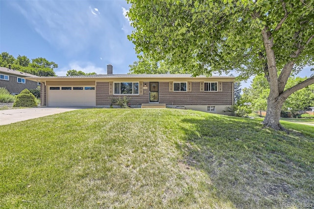 single story home featuring an attached garage, brick siding, driveway, a chimney, and a front yard