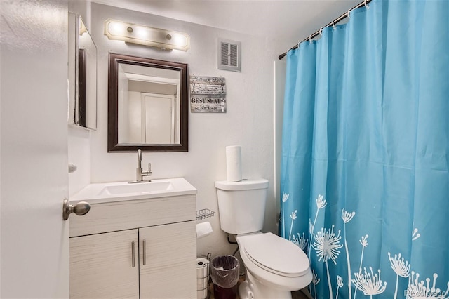 bathroom with toilet, curtained shower, vanity, and visible vents