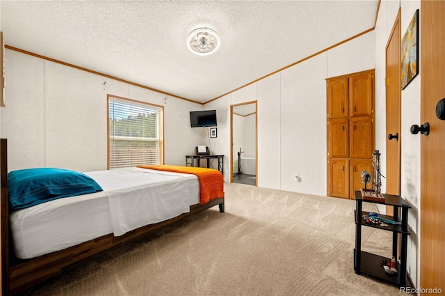 carpeted bedroom featuring a textured ceiling, lofted ceiling, and ornamental molding