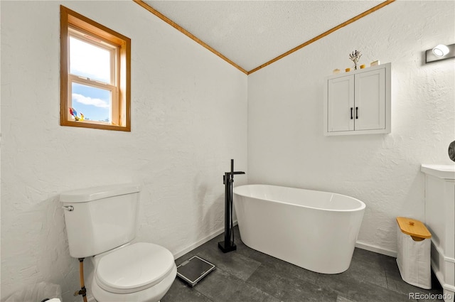 full bathroom with lofted ceiling, toilet, a textured wall, and a freestanding bath