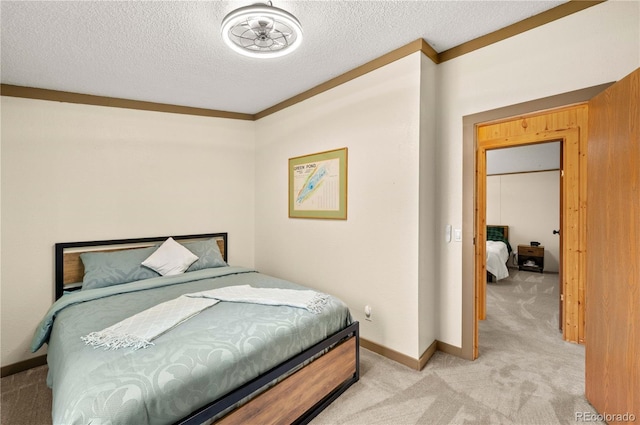 bedroom with baseboards, light colored carpet, and a textured ceiling