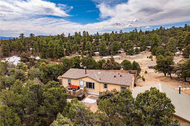 aerial view featuring a wooded view