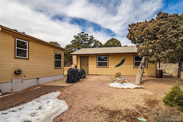 back of property featuring metal roof