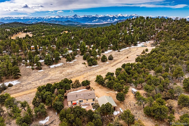 bird's eye view with a forest view and a mountain view