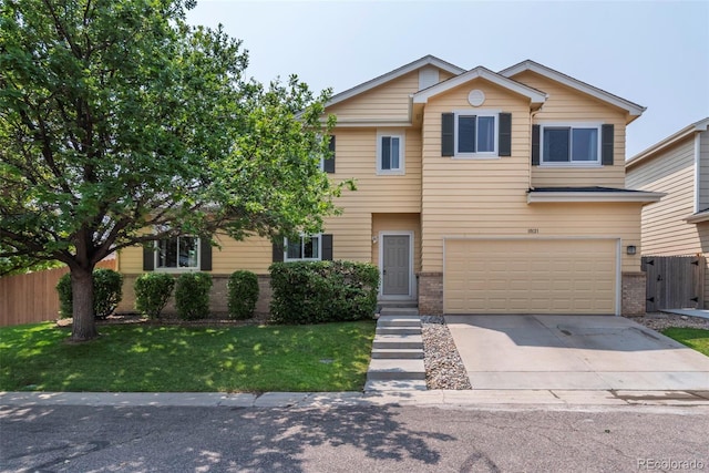 view of front of property featuring a garage and a front yard