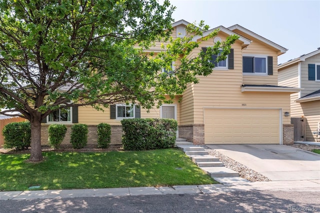 view of front of property with a garage and a front lawn