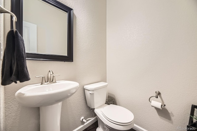 15576 W Washburn Cir, Lakewood, CO 80228 - half bath with baseboards, toilet, and a textured wall