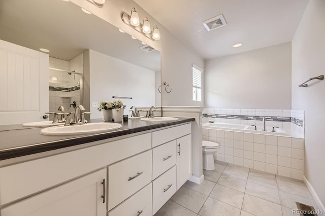 15576 W Washburn Cir, Lakewood, CO 80228 - bathroom featuring double vanity, a bath, toilet, tiled shower, and recessed lighting