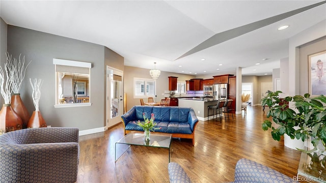 6945 N Fargo Trl, Littleton, CO 80125 - living area featuring wood finished floors, baseboards, and lofted ceiling