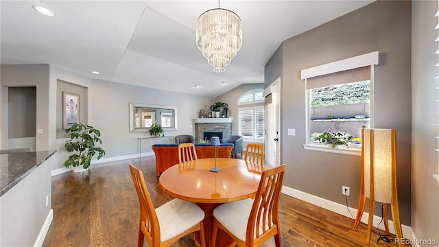 6945 N Fargo Trl, Littleton, CO 80125 - dining space featuring a fireplace, wood finished floors, baseboards, a chandelier, and recessed lighting